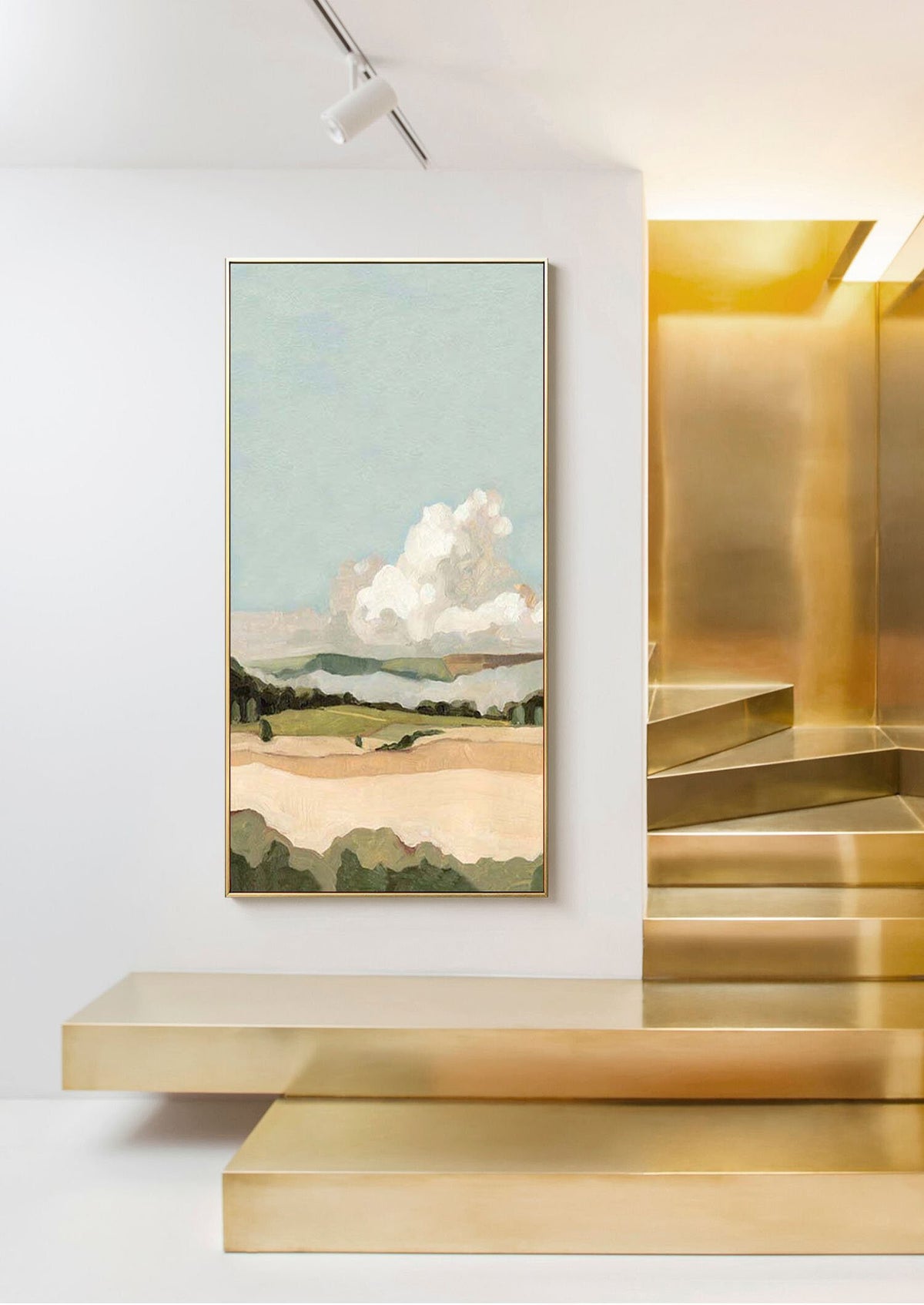 May include: Abstract landscape painting with a large white cloud in a blue sky over a green and brown field. The painting is framed in gold and hanging on a white wall.