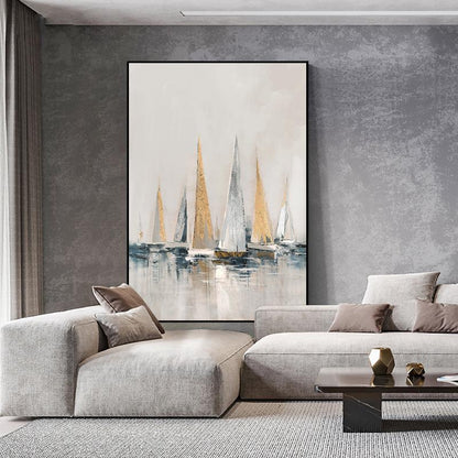 May include: Abstract painting of sailboats in shades of white, gray, and gold on a light gray background. The sailboats are arranged in a row, with the largest sailboat in the center. The painting is framed in a black frame.