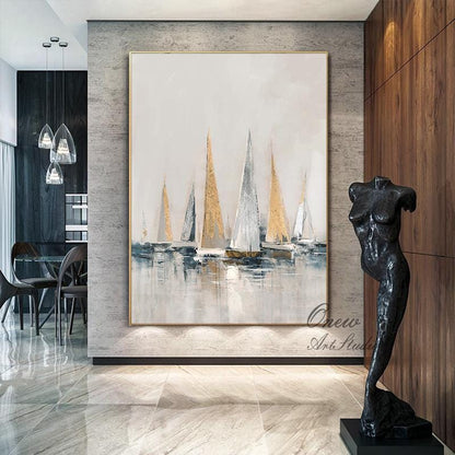 May include: Abstract painting of sailboats on a body of water with gold and white accents. The painting is framed in a gold frame and is hanging on a wall in a modern home.