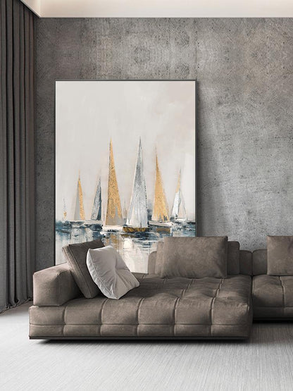 May include: Abstract painting of sailboats in shades of white, gold, and blue on a white background. The painting is hanging on a gray wall above a brown sectional sofa.