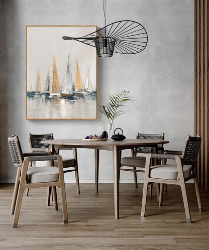 May include: A dining room with a wooden table and chairs. The table has a light wood finish and the chairs have woven seats. A painting of sailboats in shades of blue, white, and gold hangs on the wall above the table. A black metal light fixture hangs from the ceiling.