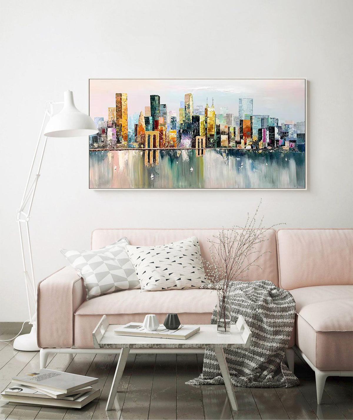 May include: A colorful abstract painting of a cityscape with buildings reflected in the water. The painting is framed in a white frame and is hanging on a white wall.
