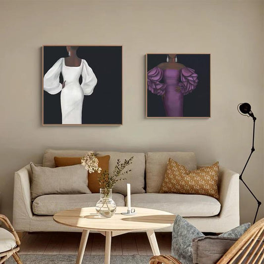 May include: Two framed paintings of women in elegant dresses. The woman in the left painting is wearing a white dress with large, puffy sleeves. The woman in the right painting is wearing a purple dress with large, ruffled sleeves.