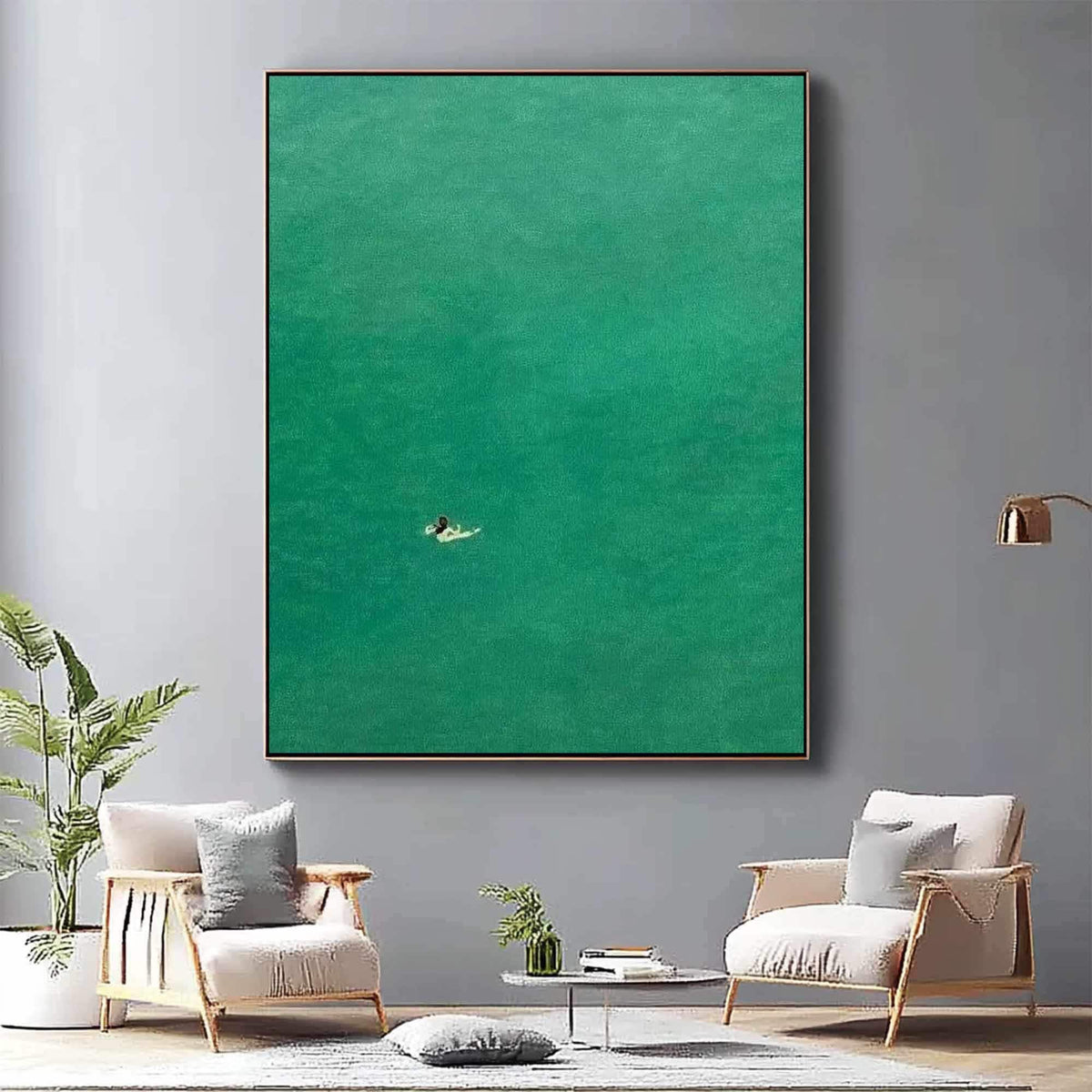 May include: A painting of a single person swimming in a vast expanse of turquoise water. The painting has a minimalist style and is framed in a simple, brown frame.