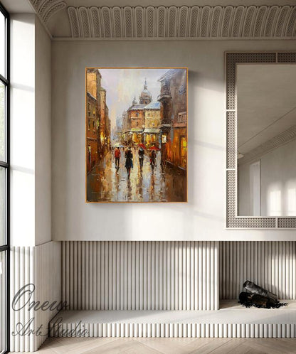 May include: A painting of a city street scene with people walking under umbrellas. The buildings are painted in warm tones of yellow, orange, and brown. The sky is a light blue with a few clouds. The painting has a vintage feel.