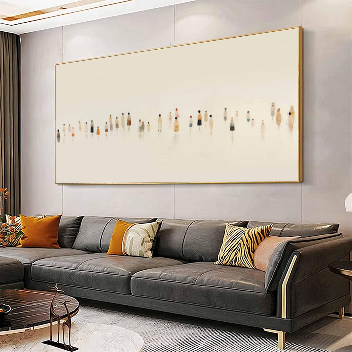 May include: Large rectangular framed artwork featuring an abstract depiction of numerous figures in muted tones against a cream background. The artwork is mounted above a dark gray sectional sofa with orange and patterned throw pillows.