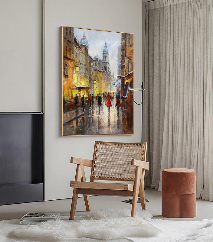 May include: A painting of a city street scene with buildings, people walking, and a church in the background. The painting is done in a realistic style with a warm color palette.
