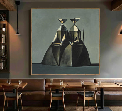 May include: Abstract painting featuring two figures in dark dresses and hats, set against a muted gray background. The artwork, framed in wood, evokes a sense of mystery and elegance, suitable for modern decor.