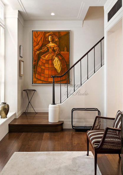 May include: An abstract painting of a woman in a dress, rendered in shades of orange and brown, hangs on a white wall. The artwork is the focal point of a well-lit hallway with a dark wood floor, a staircase, and a decorative chair.