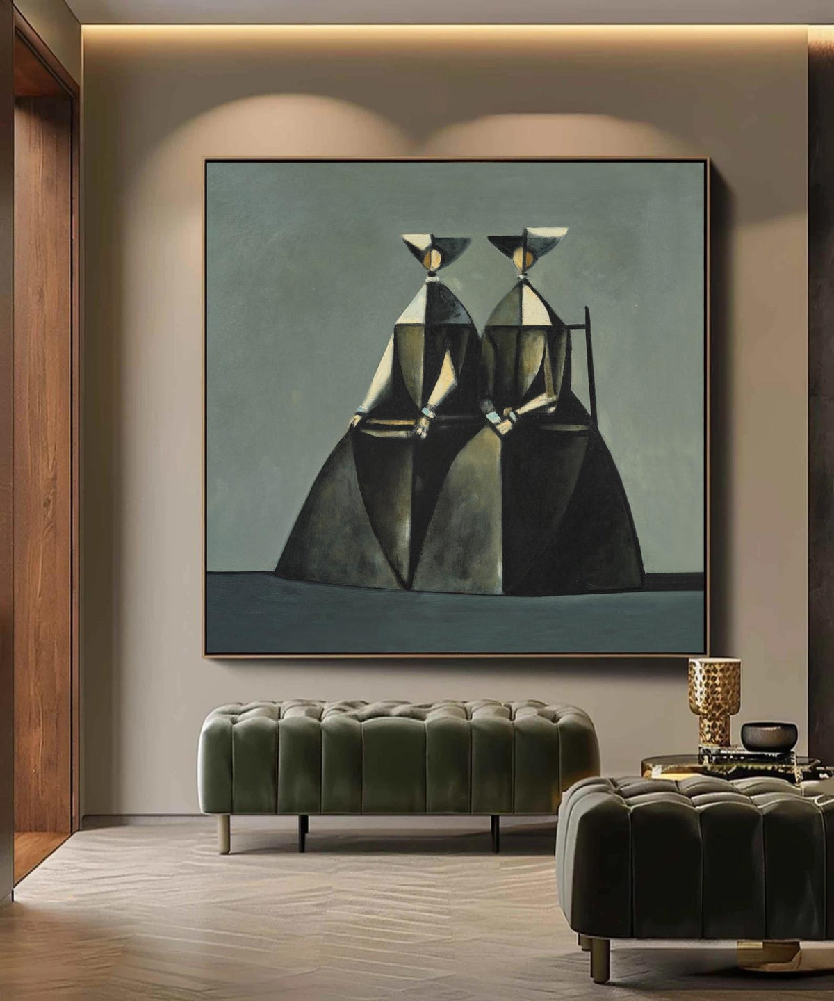 May include: Abstract painting featuring two figures in dark attire with geometric shapes and hats. The artwork is framed in a gold border and hangs above a green velvet ottoman. The figures are seated, with a muted color palette.