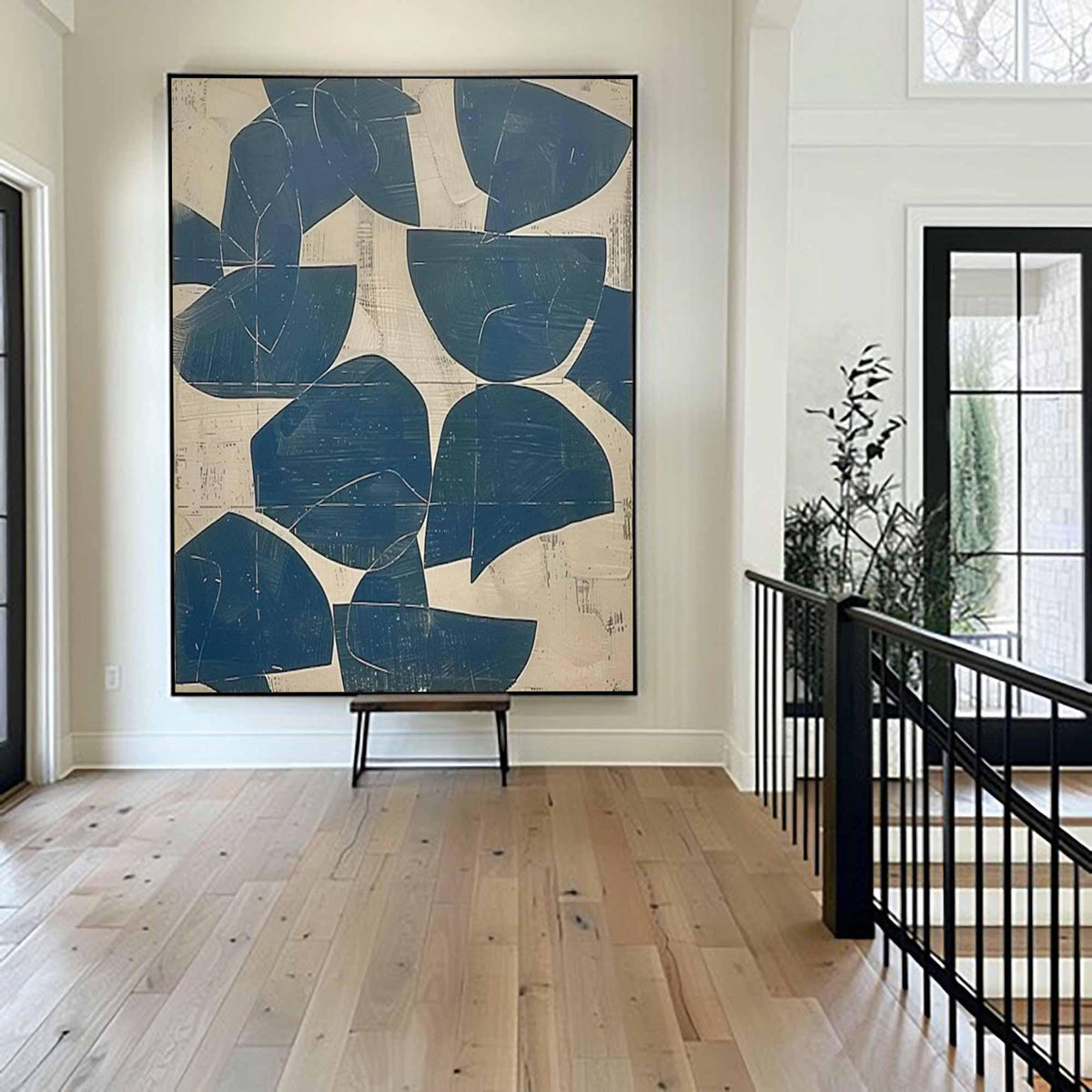 May include: A large rectangular wall art piece featuring a series of dark blue semi-circular and abstract shapes layered over a textured cream-colored background, framed in a thin black border and mounted on a light-colored interior wall.