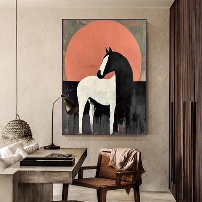 May include: Abstract art print of a horse. The horse is white and black, set against a large orange circle and a dark background. The artwork is framed and mounted on a wall in a room with a desk and chair.