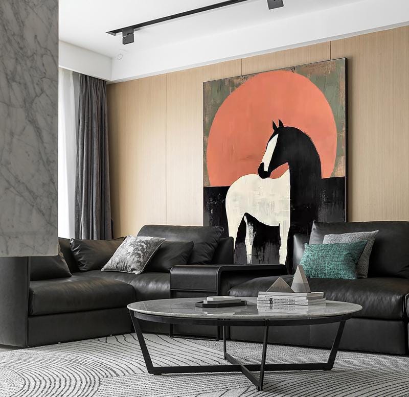 May include: A modern living room featuring a large abstract painting of a horse against a red sun. The room includes a black leather sofa, a round coffee table, and a patterned rug. The artwork is the focal point of the room.