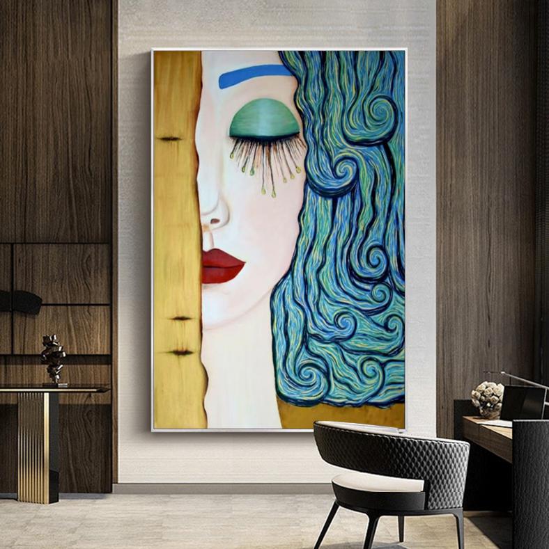 May include: A framed abstract painting featuring a woman's face. The artwork showcases a woman with blue hair, a teal eye, and red lips. The painting has a gold and white background.