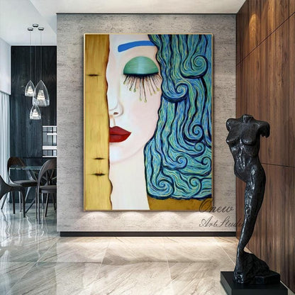 May include: A large framed painting of a woman's face, with one side in gold and the other in shades of blue and green. The woman has red lips and long eyelashes. A black sculpture of a female torso stands nearby.