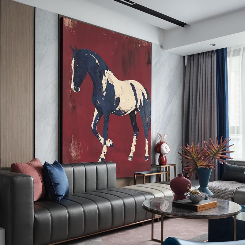 May include: Large abstract painting of a horse in navy blue and cream against a deep red background. The artwork is displayed in a modern living room setting, above a black leather sofa with decorative pillows.