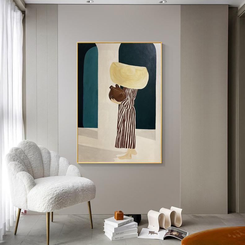 May include: An abstract painting with a gold frame depicts a figure carrying vessels. The figure wears a striped dress and carries a large, light-yellow object on their head and a brown object in their arms. The background features teal and white archways.