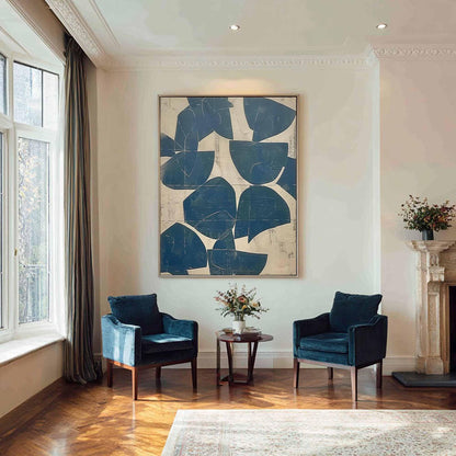 May include: A large rectangular wall art piece featuring abstract dark blue semi-circular shapes on a cream-colored background, displayed in a room with two dark blue velvet armchairs and a small wooden side table between them.