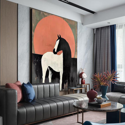 May include: Large abstract painting of a horse in black and white against a peach-colored sun. The artwork is displayed above a black leather sofa with colorful throw pillows. The room has modern decor with a round coffee table and decorative vases.