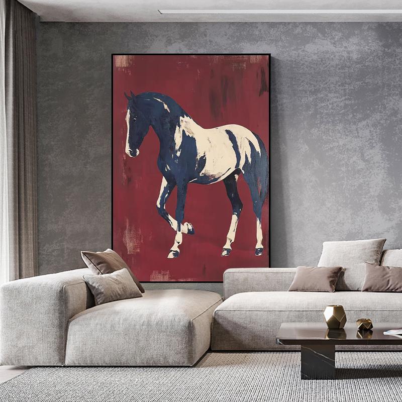May include: A framed abstract painting of a horse in motion. The horse is depicted in navy blue and cream against a deep red background. The artwork is displayed in a modern living room setting.