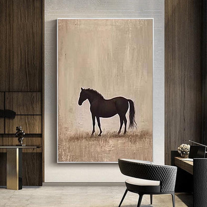 May include: A framed canvas art print featuring a silhouette of a black horse standing in a field. The background is a muted beige, with subtle brushstrokes suggesting a landscape. The artwork is displayed in a modern interior setting.