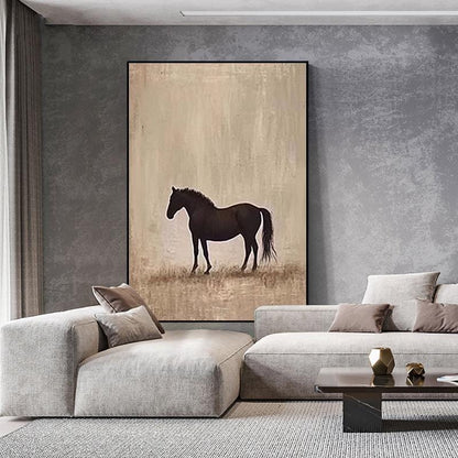 May include: A framed canvas art print featuring a dark brown horse silhouette against a beige and brown background. The artwork is displayed in a modern living room setting, with a gray sofa and coffee table.