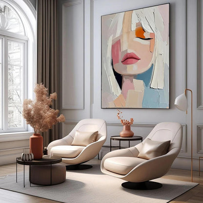 May include: An abstract painting of a woman's face with closed eyes, featuring white hair and a palette of pink, orange, and blue. The artwork hangs above two cream-colored swivel chairs in a modern living room setting.