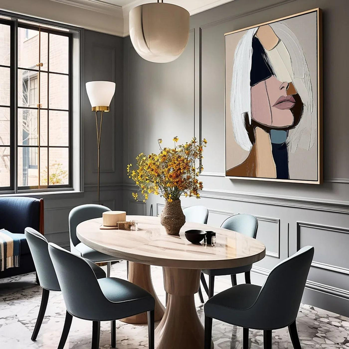May include: A dining room featuring a light wood oval table with six teal chairs. A large abstract painting hangs on the wall. A vase of yellow flowers sits on the table. A modern floor lamp and a large window are also visible.