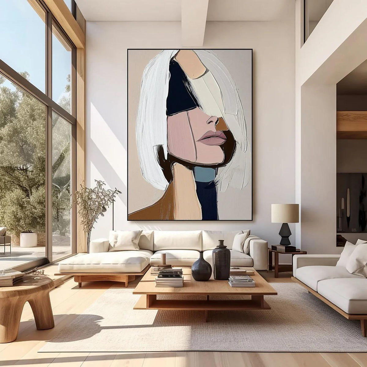 May include: Large abstract painting of a woman's face with a modern aesthetic. The artwork features a palette of white, pink, black, and beige. The woman's face is partially obscured by white brushstrokes, creating a textured effect. The painting is displayed in a modern living room.