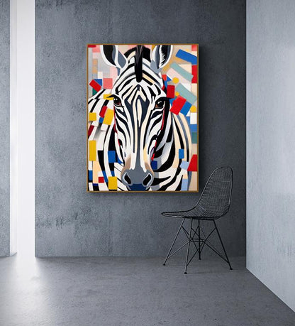 May include: A framed artwork featuring a stylized zebra portrait. The zebra has black and white stripes, a gray nose, and brown eyes. The background is a colorful abstract design with red, blue, yellow, and white shapes. The artwork is displayed on a gray wall.