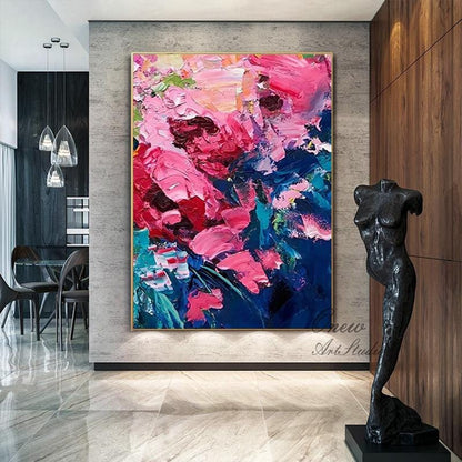 May include: Large abstract floral painting with thick brushstrokes in shades of pink, red, blue, and green. The artwork is framed in gold and hangs on a gray wall. A black sculpture of a torso stands nearby.