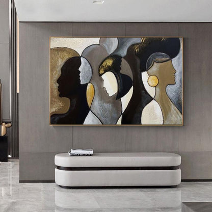 May include: Abstract painting featuring stylized profiles in shades of black, gold, and neutral tones. The artwork is framed in gold and hangs above a white bench. The painting's composition includes multiple faces.