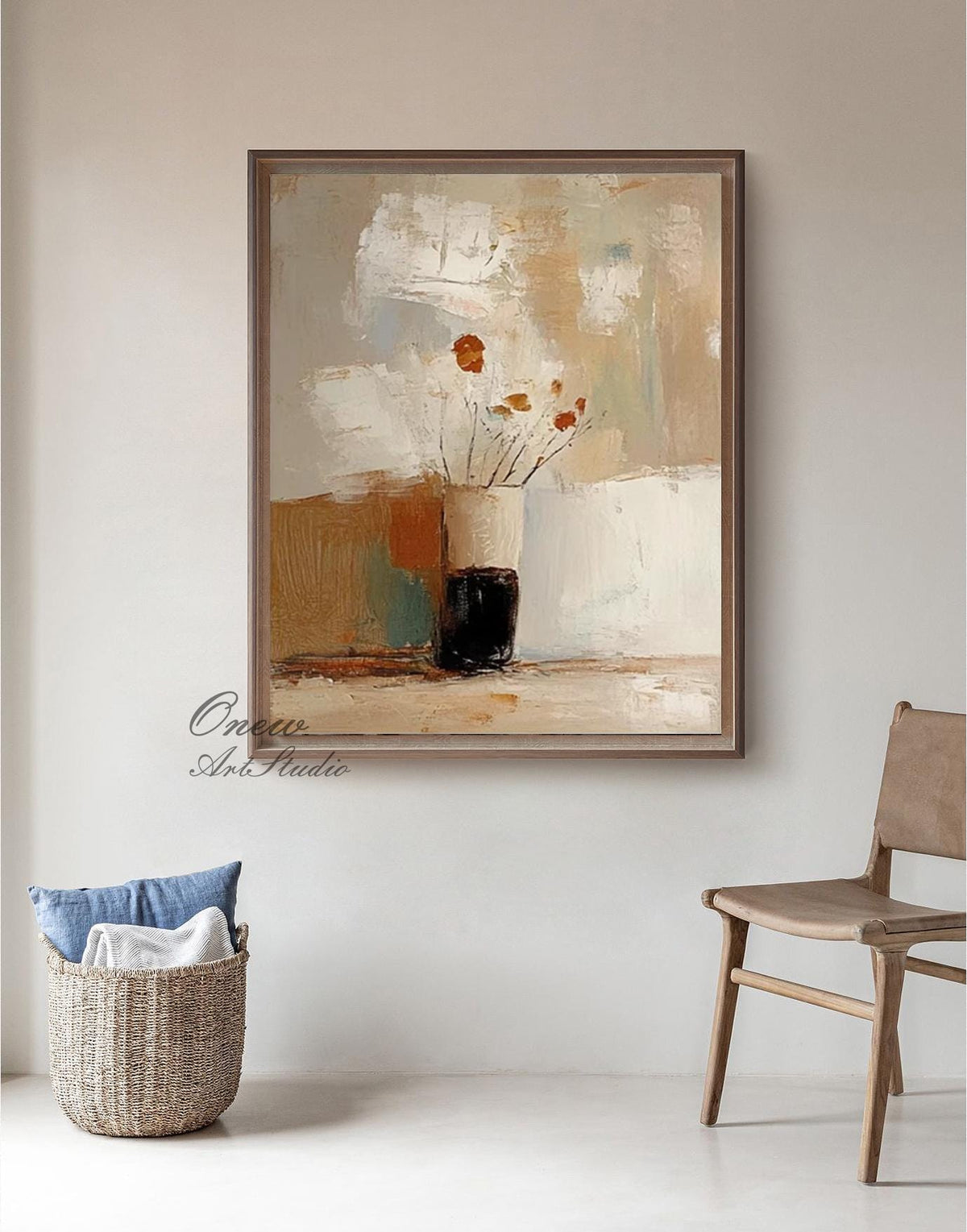 May include: Abstract oil painting in a wooden frame. The artwork features a vase with orange flowers against a backdrop of beige, white, and brown brushstrokes. A woven basket with blue and white textiles and a wooden chair are in the foreground.