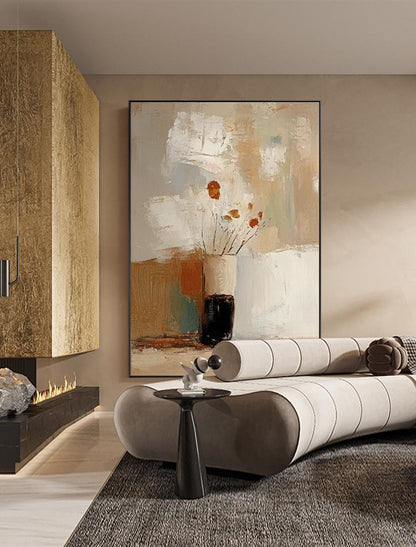 May include: Abstract art painting featuring a vase with orange flowers. The artwork has a neutral color palette with beige, brown, and white tones. A black side table and a curved sofa are in the foreground.