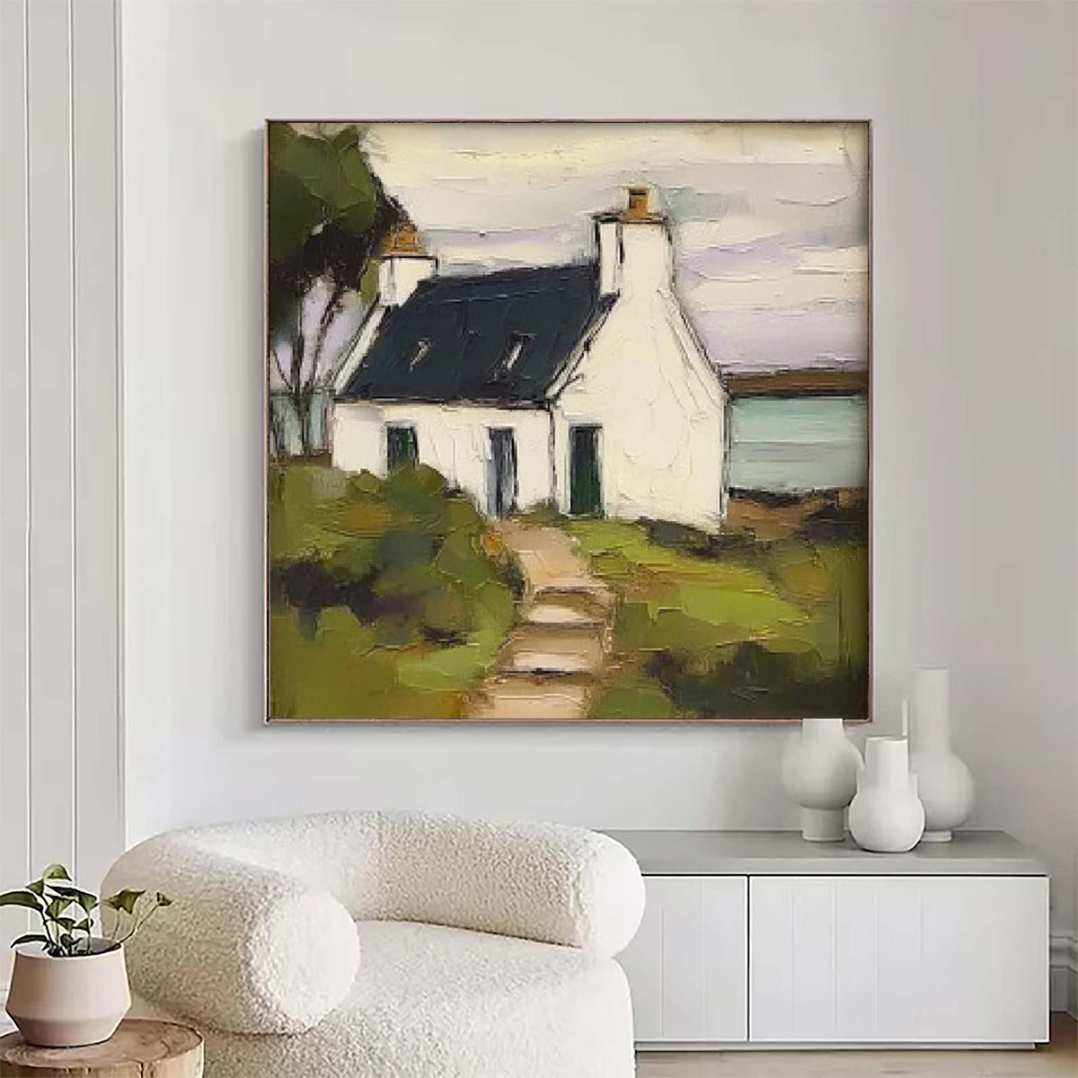 May include: An oil painting on canvas depicting a white cottage with a dark roof and a chimney, situated in a landscape with green fields and a path leading to the entrance. The artwork features visible brushstrokes and a muted color palette.