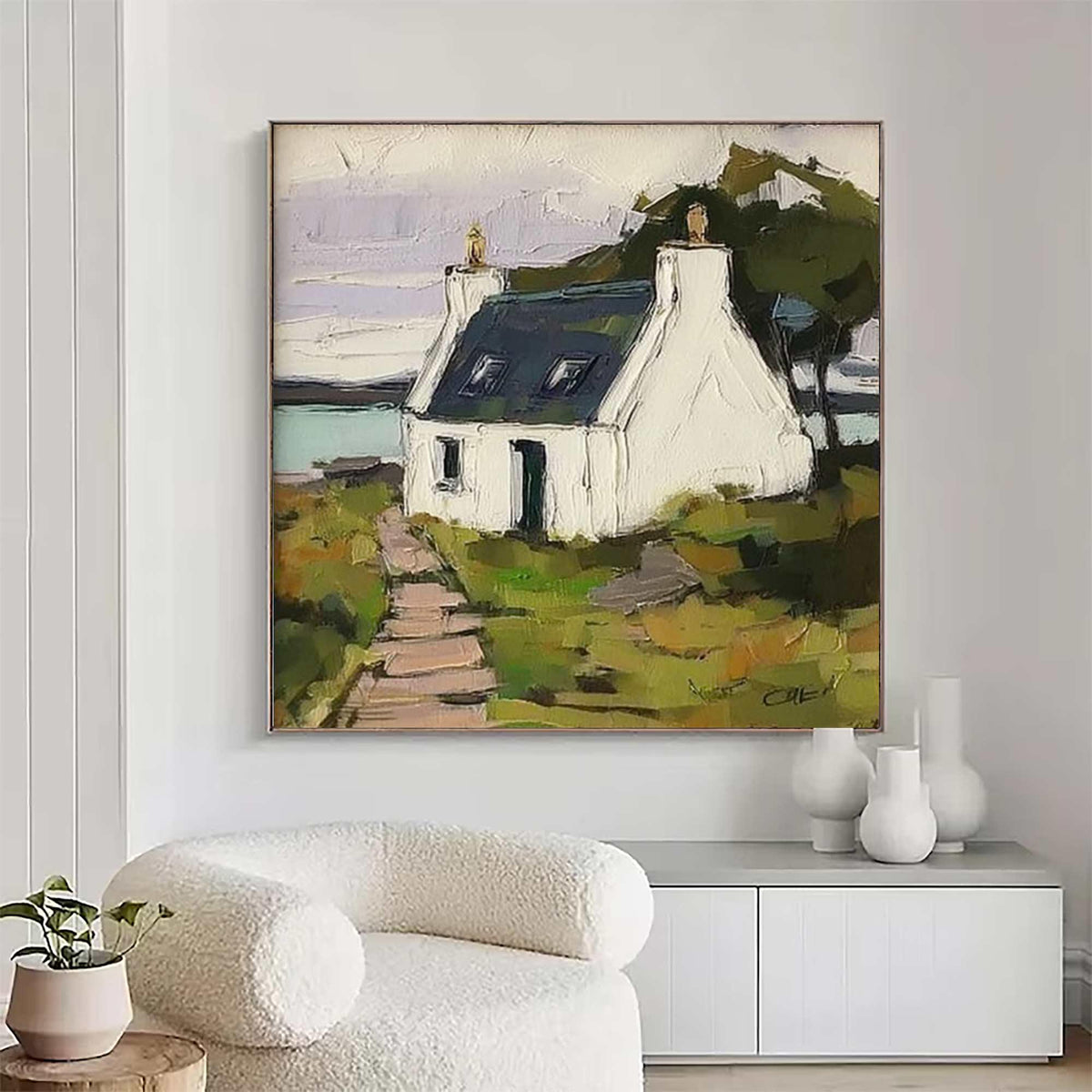 May include: A square oil painting on canvas depicting a white cottage with a dark blue roof situated in a green landscape. A stone path leads to the house, with a body of water in the background under a pale sky. The artwork features thick brushstrokes.