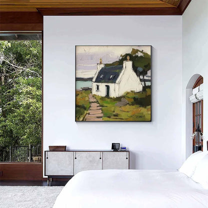 May include: A square wall art print featuring an impressionistic painting of a white cottage with a dark roof, situated on a grassy landscape with a stone path leading to the entrance, set against a backdrop of a body of water and a pale sky.