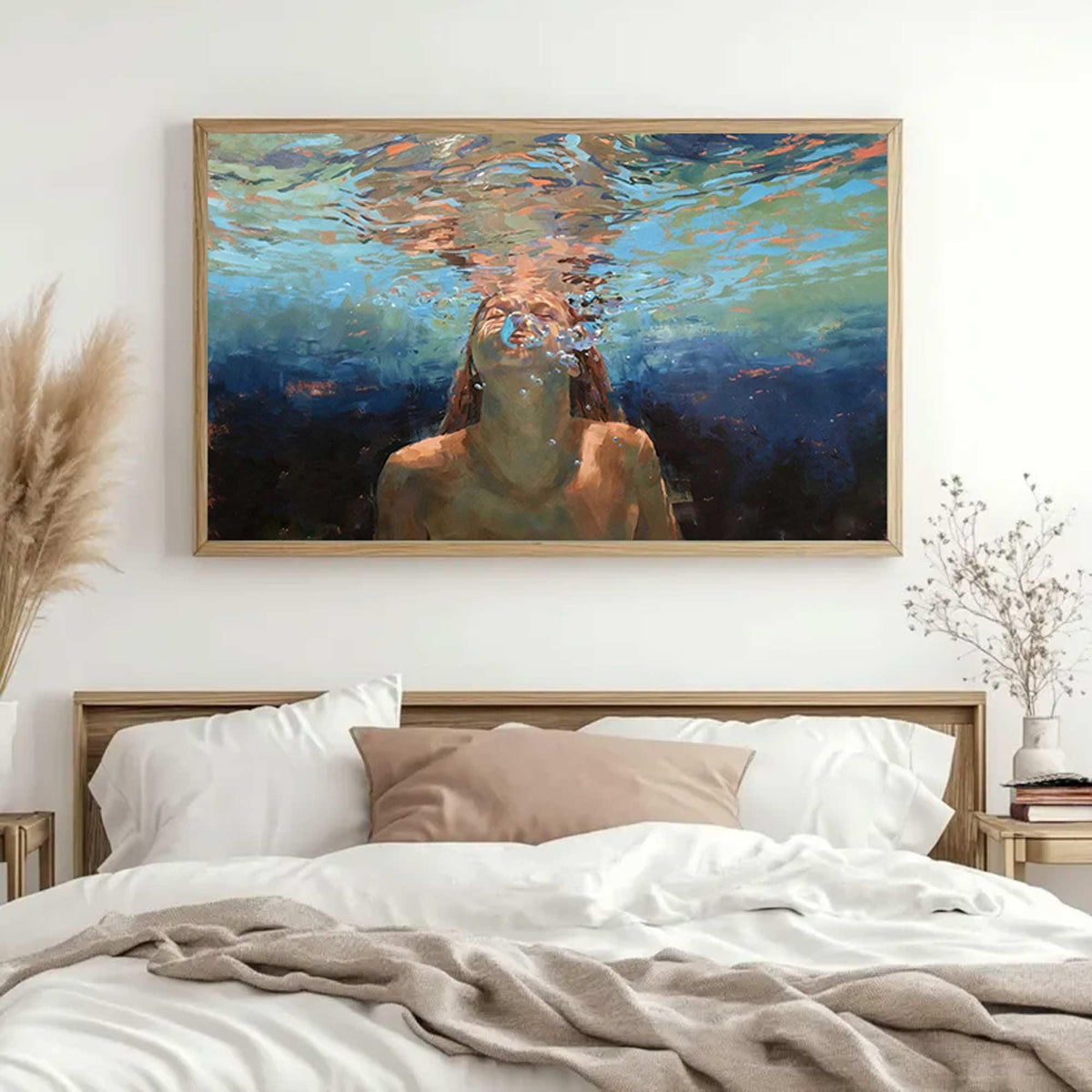 May include: A framed art print depicts a person underwater, exhaling bubbles. The painting features a palette of blues, oranges, and browns, with the subject's face and upper body visible. The artwork is displayed above a bed with white linens.