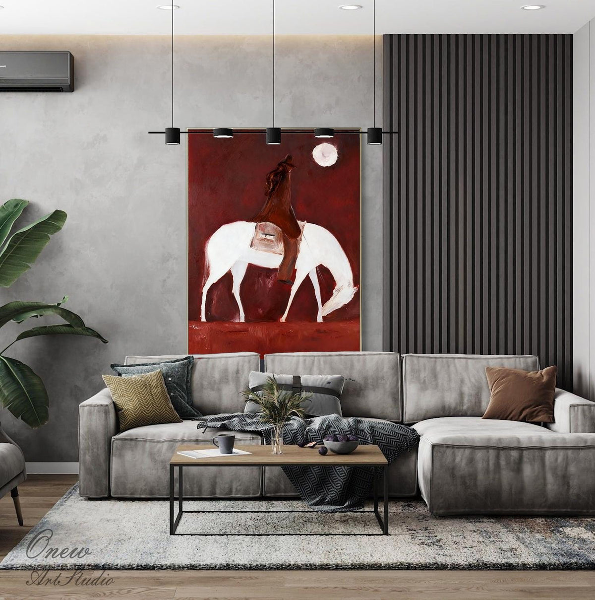 May include: An abstract painting depicts a figure on horseback with a white horse against a deep red background. The artwork, with a minimalist style, features a full moon and is displayed above a gray sectional sofa in a modern living room setting.