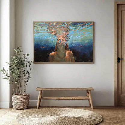 May include: A framed painting depicts a person underwater, with light filtering through the water. The artwork features shades of blue, orange, and brown, creating a serene and ethereal atmosphere. The painting is displayed above a wooden bench.