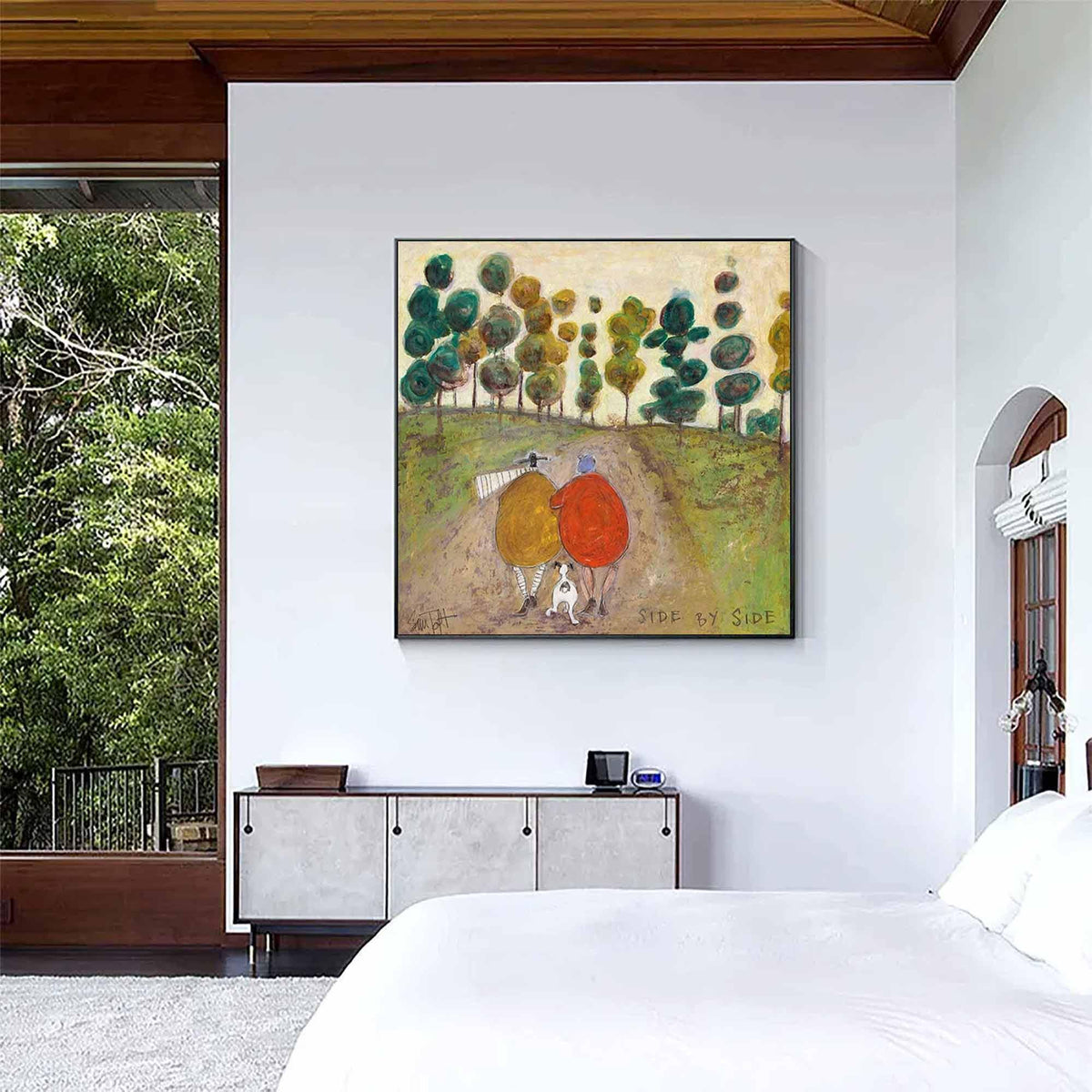 May include: A square wall art print featuring a painting of two figures in yellow and red coats walking with a small white dog on a dirt path. The background shows a row of stylized green and yellow trees under a beige sky. The text SIDE BY SIDE is visible.