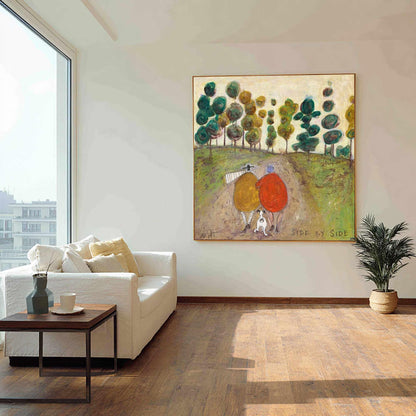 May include: A square painting titled Side by Side featuring two figures in yellow and red coats walking with a small dog on a dirt path through a green landscape with stylized trees. The artwork is displayed on a wall above a white sofa.