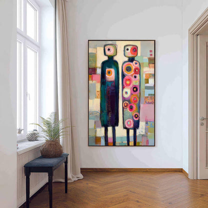 May include: A rectangular wall painting featuring two stylized, tall, thin figures standing side-by-side. The left figure is dark teal with a single circular chest detail, while the right figure is covered in numerous colorful, concentric circles.