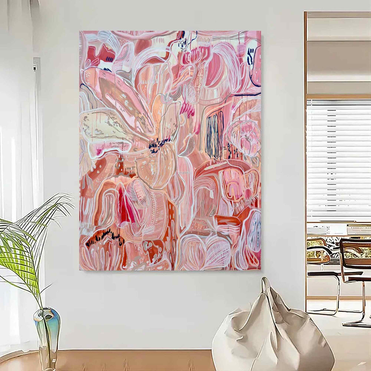 May include: Large abstract painting with a floral theme. The artwork features a blend of pink, peach, and white hues, with bold brushstrokes and organic shapes. The canvas is mounted on a white wall, creating a modern and artistic aesthetic.