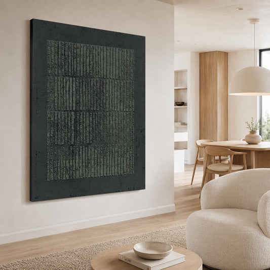 May include: Large, rectangular abstract wall art with a dark gray textured surface. The artwork features a series of vertical lines within a darker gray border, creating a modern, minimalist aesthetic. The piece is mounted on a white wall.