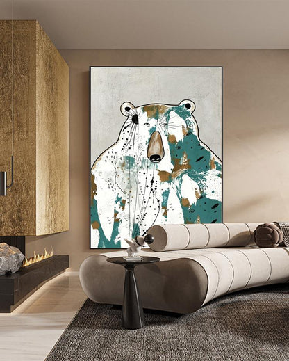 May include: Abstract bear art print. The artwork features a bear with a white body, brown nose, and teal and brown accents. The bear is set against a light gray background. The art is framed in a black frame and is displayed in a modern living room.