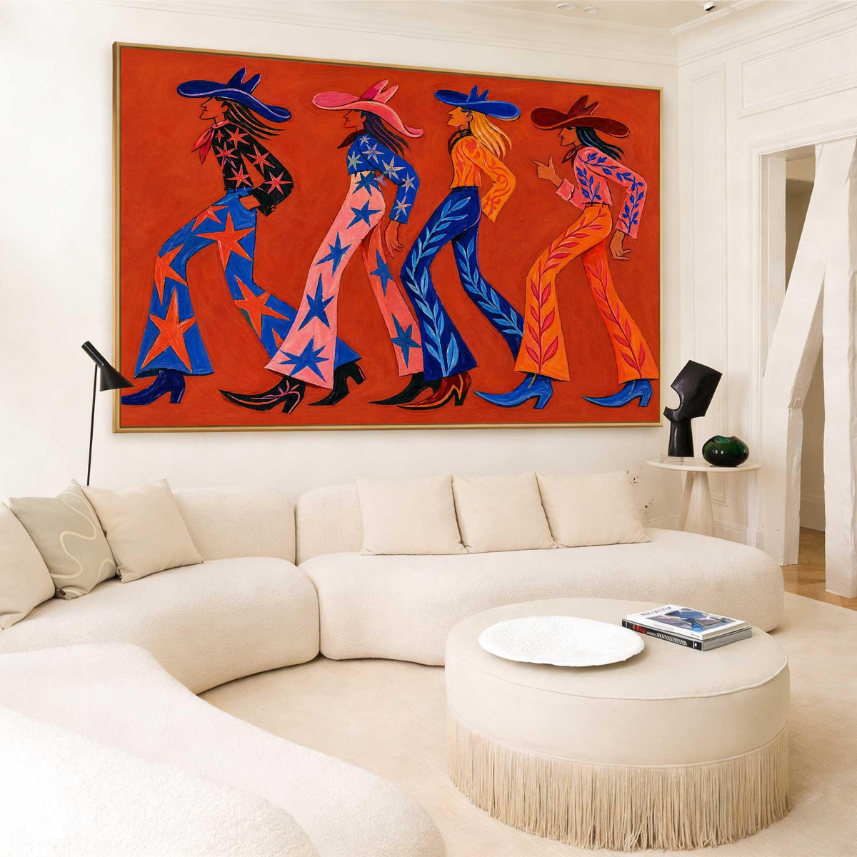 May include: A large rectangular wall art piece featuring a vibrant orange background with four stylized figures wearing wide-brimmed hats and flared pants. The figures are depicted in profile, walking in a line, adorned with star and leaf patterns.