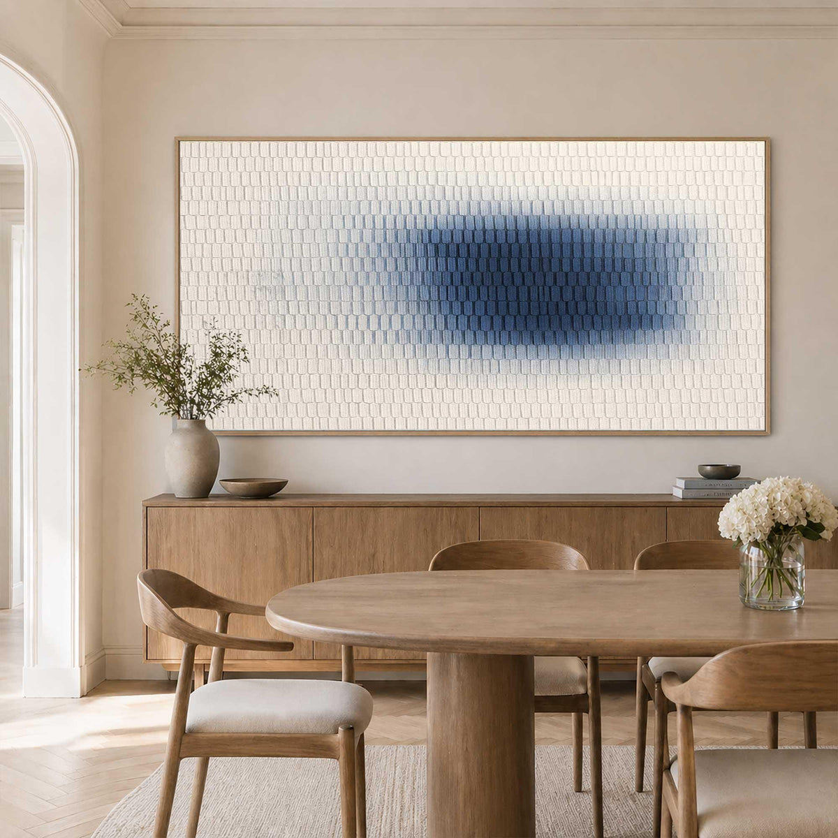 May include: A large rectangular wall art piece featuring a textured surface of small, repeating off-white tiles. A central, horizontal gradient of deep blue pigment fades into the surrounding cream-colored tiles, creating a soft, blurred effect.