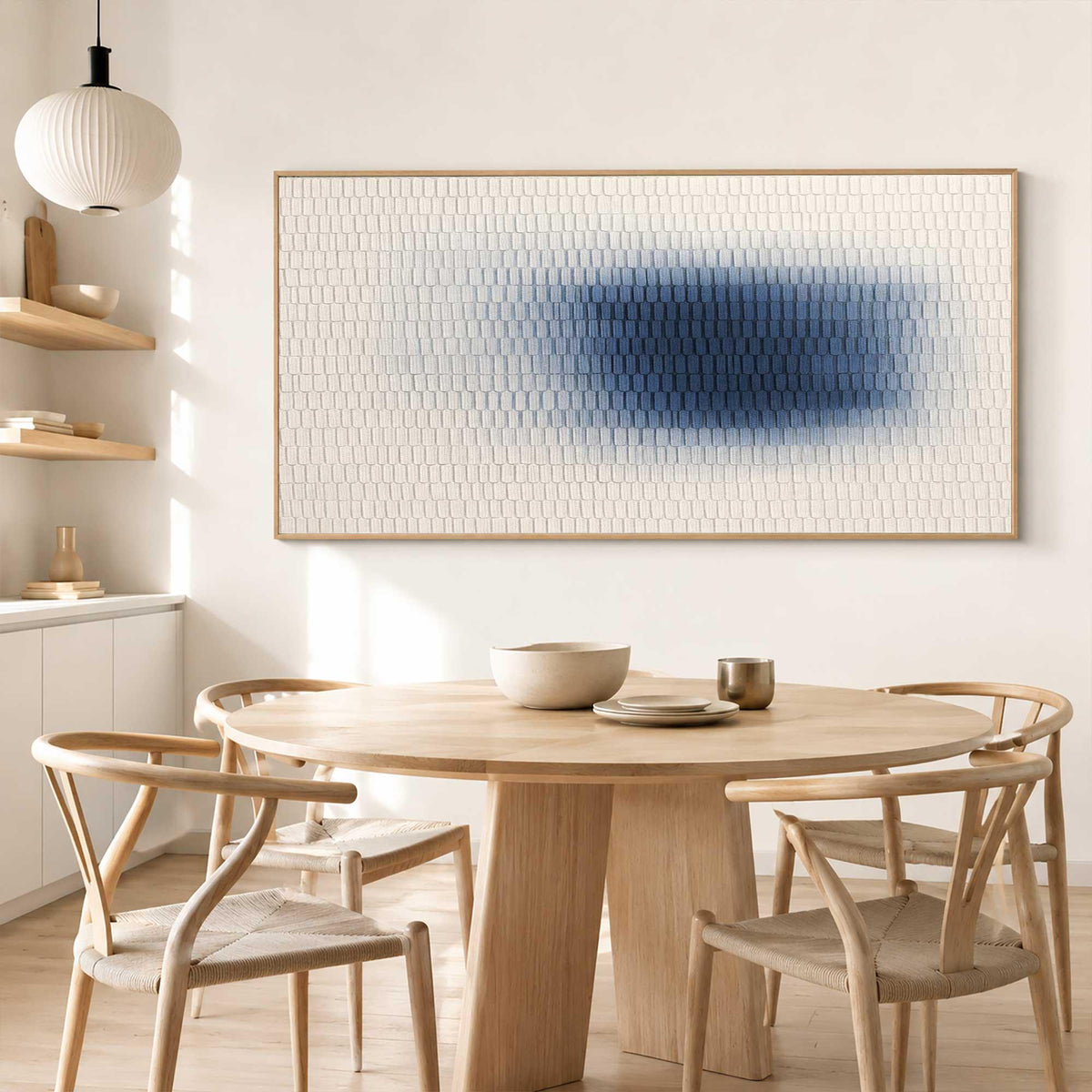 May include: A large rectangular wall art piece featuring a textured grid of small white squares that transition into a deep blue gradient at the center. The artwork is framed in a light wood border and hangs horizontally on a plain white wall.