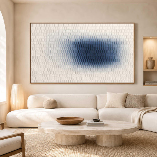 May include: A large rectangular wall art piece featuring a textured white surface with a central gradient of deep blue. The artwork is composed of small, repeating vertical rectangular segments that create a uniform, grid-like pattern across the canvas.